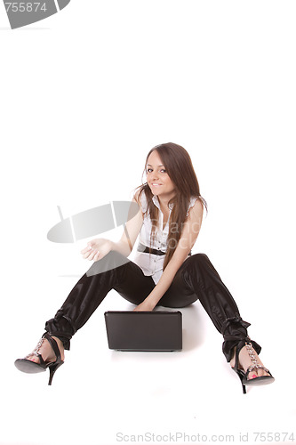 Image of casual woman with a laptop, working on the floor.
