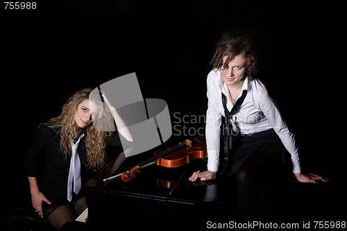 Image of Two beautiful young women with violon and piano