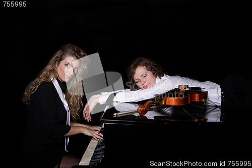 Image of Two beautiful young women with violon and piano