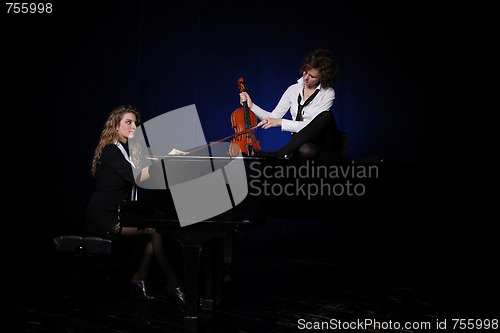 Image of Two beautiful young women with violon and piano