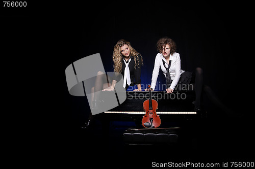 Image of Two beautiful young women with violon and piano