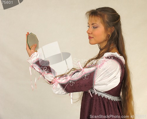 Image of Young girl looking into the glass