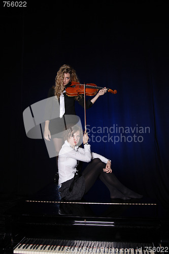 Image of Two beautiful young women with violon and piano