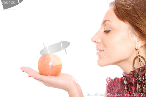 Image of A pretty young woman holding an apple 