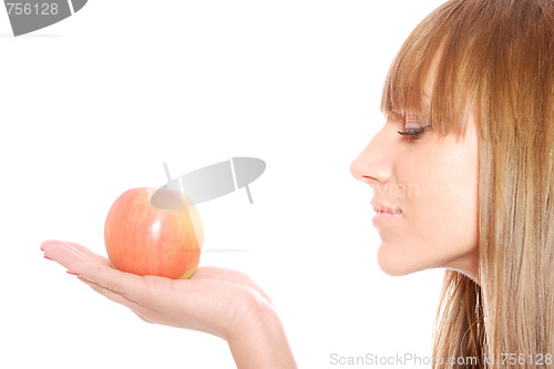 Image of A pretty young woman holding an apple 