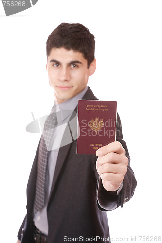 Image of  A businessman in a suit holds passport