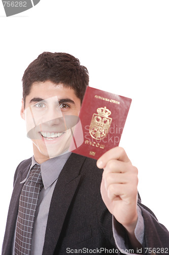 Image of  A businessman in a suit holds passport