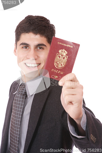 Image of  A businessman in a suit holds passport