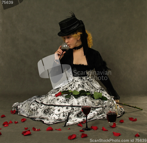 Image of Girl, red wine and rose petals