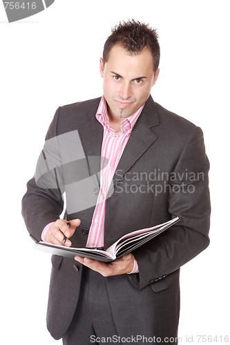 Image of Confident businessman with notebook