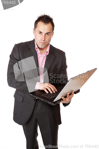 Image of Happy businessman holding laptop computer