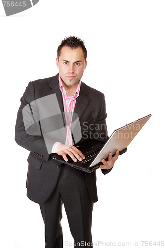Image of Happy businessman holding laptop computer