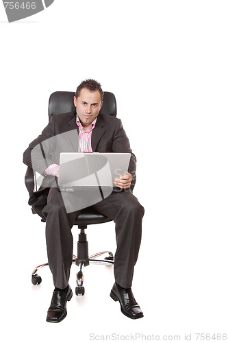 Image of Relaxed young businessman, sitting on a chair.