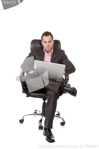 Image of Relaxed young businessman, sitting on a chair.