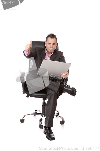 Image of Relaxed young businessman, sitting on a chair.