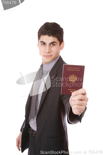Image of  A businessman in a suit holds passport