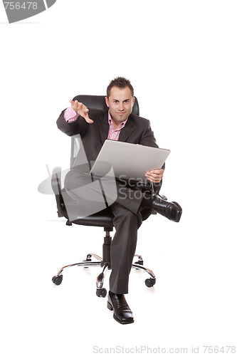 Image of Relaxed young businessman, sitting on a chair.