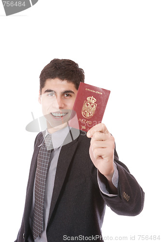 Image of  A businessman in a suit holds passport