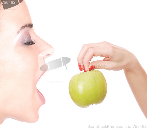 Image of A pretty young woman holding an apple 