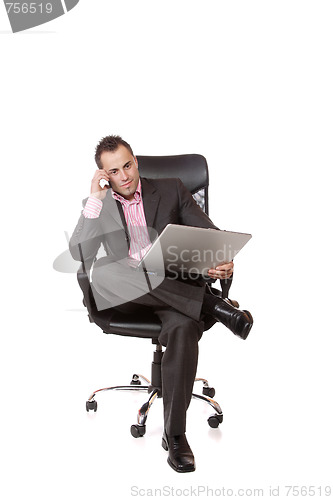 Image of Relaxed young businessman, sitting on a chair.