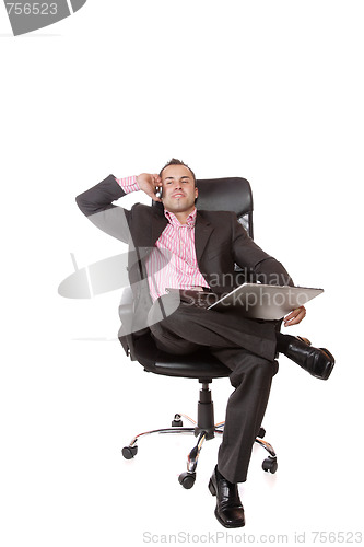 Image of Relaxed young businessman, sitting on a chair.