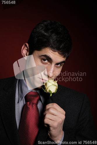 Image of  Young happy smiling handsome man with rose