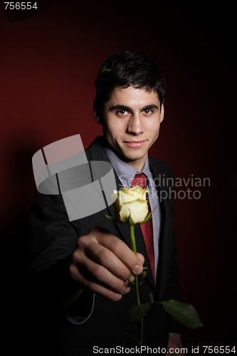 Image of  Young happy smiling handsome man with rose