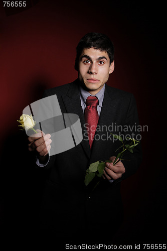 Image of  Young happy smiling handsome man with rose