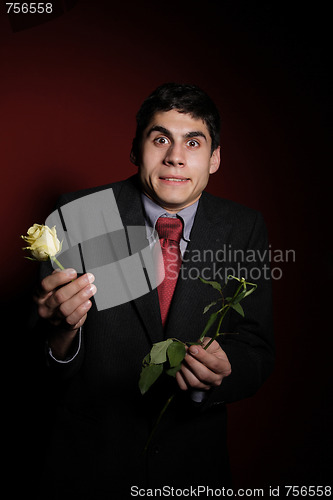 Image of  Young happy smiling handsome man with rose