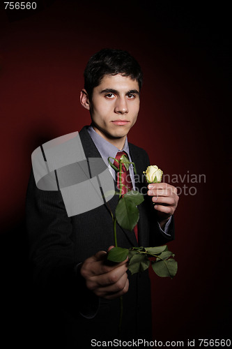 Image of  Young happy smiling handsome man with rose