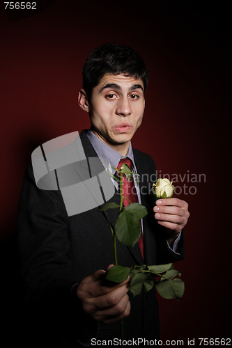 Image of  Young happy smiling handsome man with rose