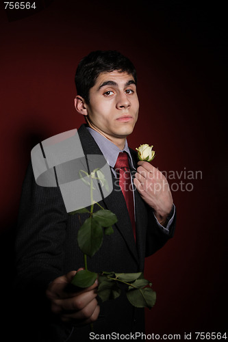 Image of  Young happy smiling handsome man with rose