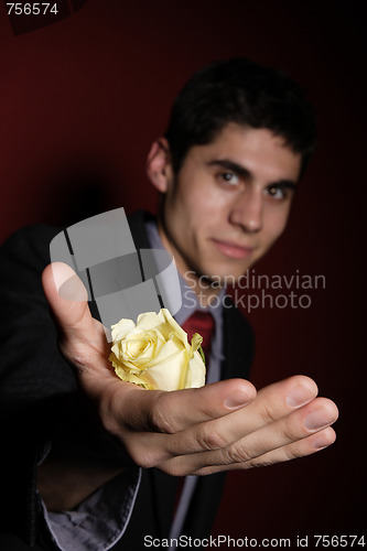 Image of  Young happy smiling handsome man with rose