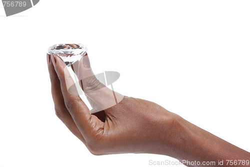 Image of Female hand holding diamond