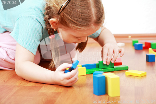 Image of Adorable girl playing with blocks