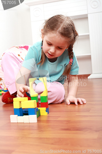 Image of Adorable girl playing with blocks