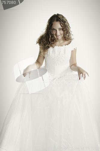 Image of Bride raising dress skirt