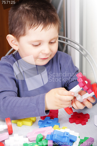 Image of Boy playing with toy blocks