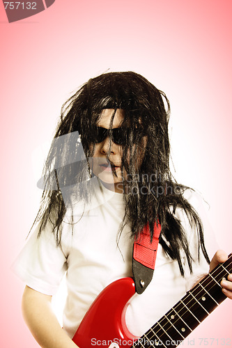 Image of Boy in wig with red guitar