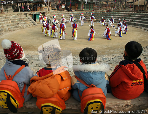 Image of School childen watching traditional dancers