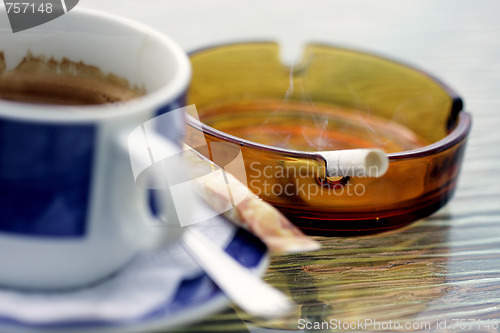 Image of Smoking cigarette and cup of coffee