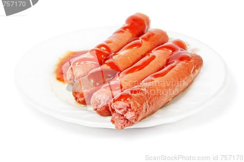 Image of Sausages dressed with ketchup