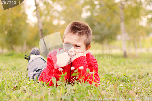 Image of Kid laying down on grass