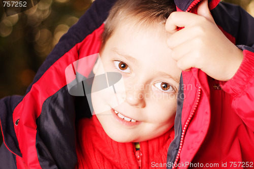 Image of Boy trying put jacket on head