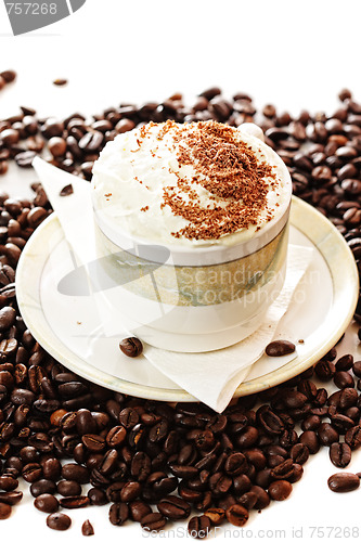 Image of Cup of cappuccino coffee on beans