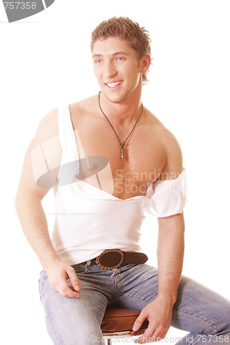 Image of Smiling guy in teared shirt on chair