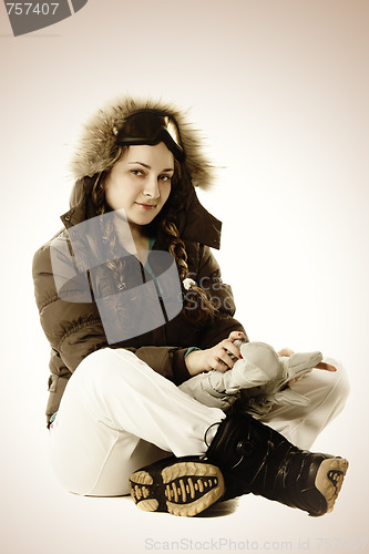 Image of Girl in brown sitting on floor