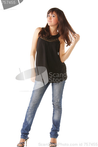 Image of Woman in jeans touching hairs