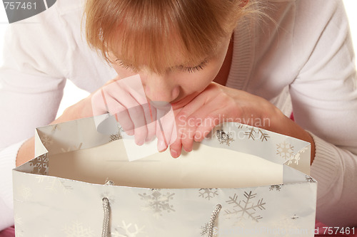 Image of Woman looking into empty bag