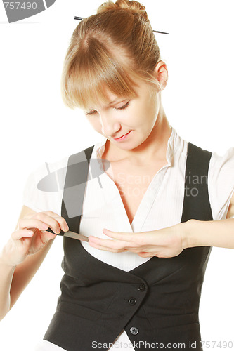 Image of Woman making manicure herself